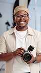 Face, photography and black man in studio, camera for visual project and magazine production. African person, artist or freelancer in workplace, equipment and videographer for digital agency or smile