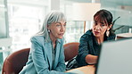 Women, discussion and research in office with computer, financial planning and review for audit. Mature people, conversation or teamwork in workplace with desktop, explain budget or finance proposal.