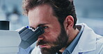 Lab, scientist and man with microscope, exam and analysis for vaccine, serious and medical research. Science, innovation and person with equipment for medicine, healthcare or investigation in clinic