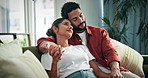 Couple, relax and holding hands on sofa with love, romantic connection and bonding together on weekend. Happy, people and cuddle in home with healthy marriage, commitment and loyalty in relationship.