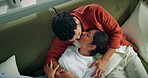 Couple, relax and laugh on sofa with kiss, romantic connection or bonding together on weekend break. Above, happy people and cuddle in home with support, affection or commitment for healthy marriage.