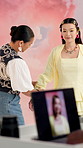 Photoshoot, stylist or women in studio with laptop, getting ready or clothing fix on set. Collaboration, fashion or model with technology, inspection or backstage preparation in media production.