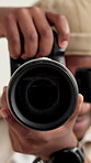 Hands, photographer and lens of camera in studio for photoshoot, filming and digital agency. Behind the scenes, face of man and capture picture for magazine catalog, photography and media production