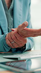 Woman, hands and wrist pain in office with computer, accounting or joint inflammation from typing. Hurt, person or accountant in workplace with desktop, keyboard or tired from carpal tunnel syndrome.