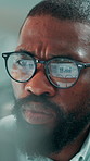 Office, glasses and businessman with computer, reading and serious with financial research and data. Economist, online and black person with tech for investment report, reflection and graph on web