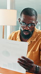 Sales agency, documents and black man in office, charts for profit increase and stress. African person, concern and employee with paperwork, worry and graphs for revenue review and startup audit