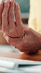 Hands, computer and typing with wrist pain at office for carpal tunnel, injury or fatigue at startup. Person, pc and joint inflammation with sore muscle, arthritis or fibromyalgia at creative agency