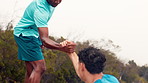 Friends, help and men in nature for fitness, hiking and exercise for adventure in nature. Athlete, outdoor and people with support for workout, trekking or training together for endurance or wellness