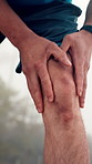 Hands, knee pain and runner in forest with injury, joint inflammation and break for exercise in morning fog. Person, outdoor and arthritis with tendinitis, fibromyalgia and fatigue with trail running