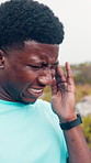 Headache, fitness and black man in nature with pain for exercise, training and workout strain. Athlete, sports and tired person with fatigue, burnout and accident for intense challenge on mountain