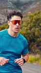 Running, athlete and man with sunglasses, outdoor and cardio for wellness on road, fitness or active. Healthy, runner and person with endurance for exercise, serious and training routine in city
