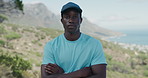 Arms crossed, hiking and serious with black man in mountains for exercise, fitness or hobby. Confident, discover and explore with African hiker outdoor in nature for activity, adventure or sports