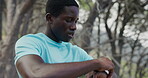 Fitness, stop or black man in nature with smart watch, progress track or break in cardio practice. Exercise, tech or runner outdoor with cool down, training check or recovery in performance update.