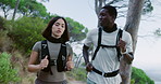 Fitness, running and couple in woods for health, body wellness and talk for cardio endurance. Woman, man and jog for workout in forest, exercise and conversation with interracial people for sports