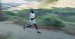 Fitness, running and black man in forest with motion blur for cardio health, wellness and fast. Speed, runner and person in nature for workout, exercise and training with energy for sports outdoor