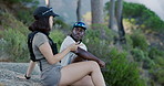 Hikers, talking and couple in woods, break and bonding with partner in nature, adventure and holiday. Outdoor, date and interracial people on vacation, conversation and hiking with hydration vest