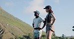People, hiking and break with rest on mountain for outdoor exercise, workout or recovery together. Interracial couple, man and woman with scenery view for sightseeing adventure or trekking journey