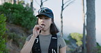 Eating, fitness and hiking with woman outdoor in nature for adventure, snack or sports hobby. Energy bar, exercise and walking with hiker person in forest for backpacking, hunger or trekking activity