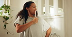 Brush, singing and woman in bathroom at apartment for music, fun or self care routine in morning. Dancing, grooming and female person with cosmetic tool as mic for karaoke in home with hygiene.