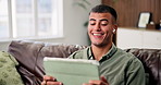 Earphones, laugh and man with tablet on sofa for relax, video or watch movie on internet in home. Audio, tech and happy person in living room for streaming service with funny show, film or comedy