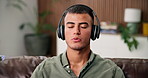 Breathing, headphones and streaming with man on sofa in home living room for sound therapy. Audio, meditation and relax with person in apartment for holistic balance, mental health or zen routine