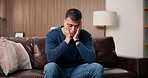 Anxiety, concern and man with depression on sofa in home living room for grief, loss or pain. Difficult, worry and stress with unhappy person in apartment for mistake, negative emotion or regret