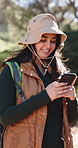 Cellphone, hiking and woman in woods, smile and digital app for direction, internet or journey update. Notification, hiker or happy person in forest, explore or smartphone for location or online maps
