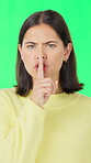 Hush, face and woman on green screen with gesture, quiet or disclosure in muted announcement. Silent, portrait or person on studio background with hand sign, confidential or shush emoji in whisper.