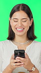 Cellphone, happy and woman by green screen for texting, communication or email on mobile app. Smile, technology and person with phone for chatting, social media or blog online by studio background.