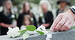 Hand, gravestone and white rose for funeral at cemetery, memorial service and pay respect. Person, graveyard and flower on tombstone for peace, grief and mourning death with family at ceremony