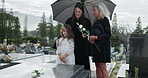 Grandparent, mom and daughter in cemetery with flowers, support and remembrance in mourning. Emotional, women and child at gravestone with roses, family comfort and shared grief with memorial visit.