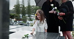 Grandparent, mom and girl in cemetery with flowers, support and remembrance in mourning. Emotional, women and child at gravestone with roses, family comfort and shared grief with memorial visit.