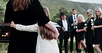 Back, person and hug kid at graveyard for funeral ceremony, burial service and mourning loss. Casket, family or embrace child for empathy, emotional ritual and tribute gathering at farewell memorial 