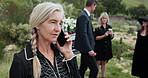 Phone call, funeral and senior woman at graveyard with communication, contact or talk for condolences. Cellphone, grief and elderly female person on mobile conversation for loss, sympathy or empathy.