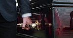 Hand, funeral and man carry coffin for death, memorial service and rest in peace with farewell. Person, grief and pallbearer walking with casket for burial ceremony, event and respect at church