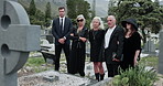 Sad, people and headstone at graveyard for funeral ceremony, burial service and mourning loss. Grief, family and cemetery for bereavement, goodbye ritual and tribute gathering at farewell memorial 