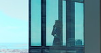 Business, phone call and view with woman in glass office for communication or discussion. Cityscape, walking and window with employee person in corporate workplace for conversation or negotiation