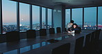 Business people, laptop and night at office with planning, conversation or documents at insurance company. Man, woman and team with project management, tech and feedback at risk assessment agency