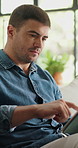 Scroll, creativity and man in home, tablet for online submission or editing for manuscript. Remote work, writer or person on sofa, review and tech for news report publication or research for schedule