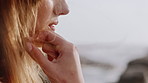 Calm, wind and woman by beach on holiday, getaway or weekend trip with space for relax. Travel, breeze and female person by ocean or sea in summer vacation for self reflection, nostalgia or memory.