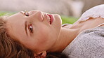 Portrait, woman and relax outdoor with lying down, thinking and contemplation for peace on vacation. Zen, female person rest and chill with reflection, calm holiday and thoughtful for serene getaway.
