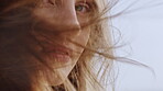 Wind, face and girl with haircare in studio for collagen treatment results, hair volume or shine. Grooming, woman or confidence with breeze on gray background for healthy texture, growth or cosmetics