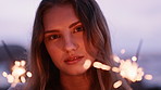 Outdoor, face or woman with sparklers for holiday, new year celebration or summer break for travel trip. Firework, sunset or person with abroad vacation for birthday weekend, nature or special event