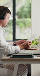 Call center, headset and man in home, documents and advice for customer service, talking or laptop. Paperwork, agent or person in lounge, pc or communication for tech support, contact us or help desk