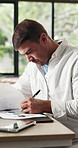 Businessman, writing and documents with pen in office for planning, project strategy or design. Man, employee or designer taking notes with paperwork for schedule, ideas or improvement in workplace