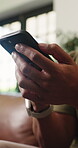 Texting, online and hands with smartphone in lounge, scroll or communication with contact on website. Typing, message and person with mobile for chat, home and browsing on social media app and tech