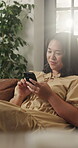 Happy, woman and relax with smartphone in lounge, browsing and communication with contact on website. House, flare and person with mobile for chat, scroll and typing message on social media app