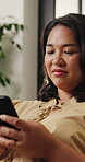 Typing, online and woman with smartphone in home, laughing and communication with contact on website. Happy, person and funny message on mobile app, reading and chatting with tech on social media