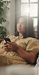 Thinking, woman and relax with smartphone in lounge, online or communication with contact on website. Typing, flare and person with mobile for chat, reflection and scroll message with tech in home