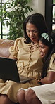Laptop, smile and relax with mother and girl on sofa for streaming service, movie choice and education show. Film subscription, bonding and online kids series with woman and daughter in family home